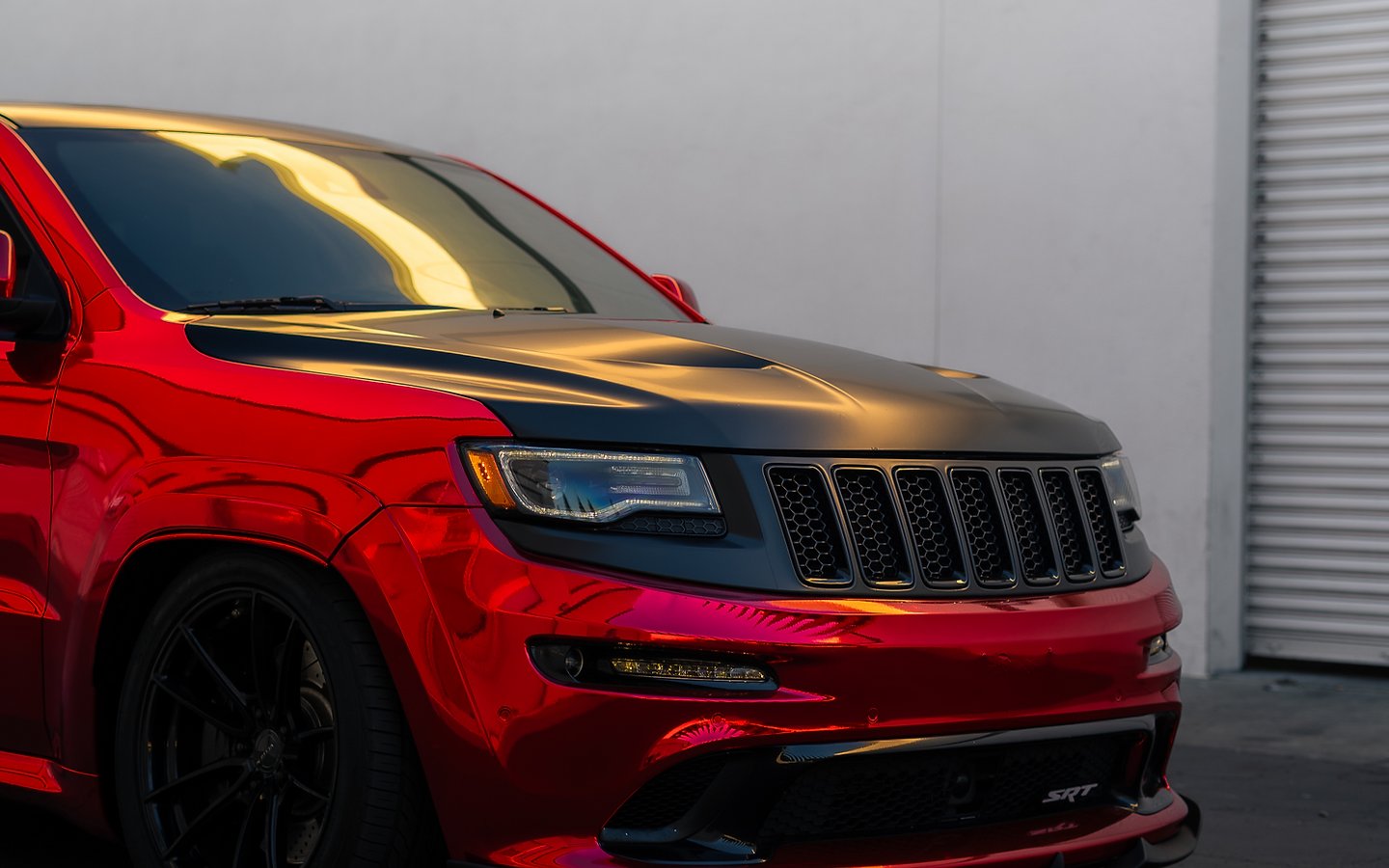 A red to black chameleon wrapped Jeep SRT, studio lit, at Temecula Auto Wraps